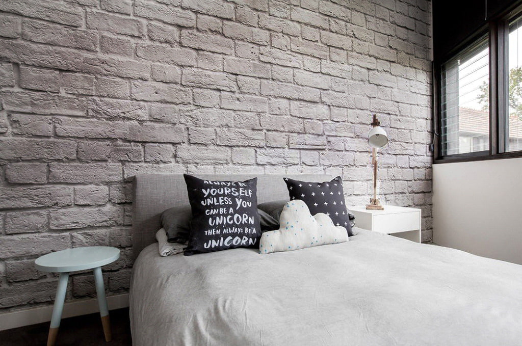 Gray brick wallpaper in the bedroom