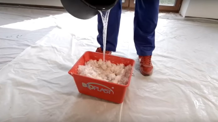 nalewanie wody do pojemnika z płynną tapetą