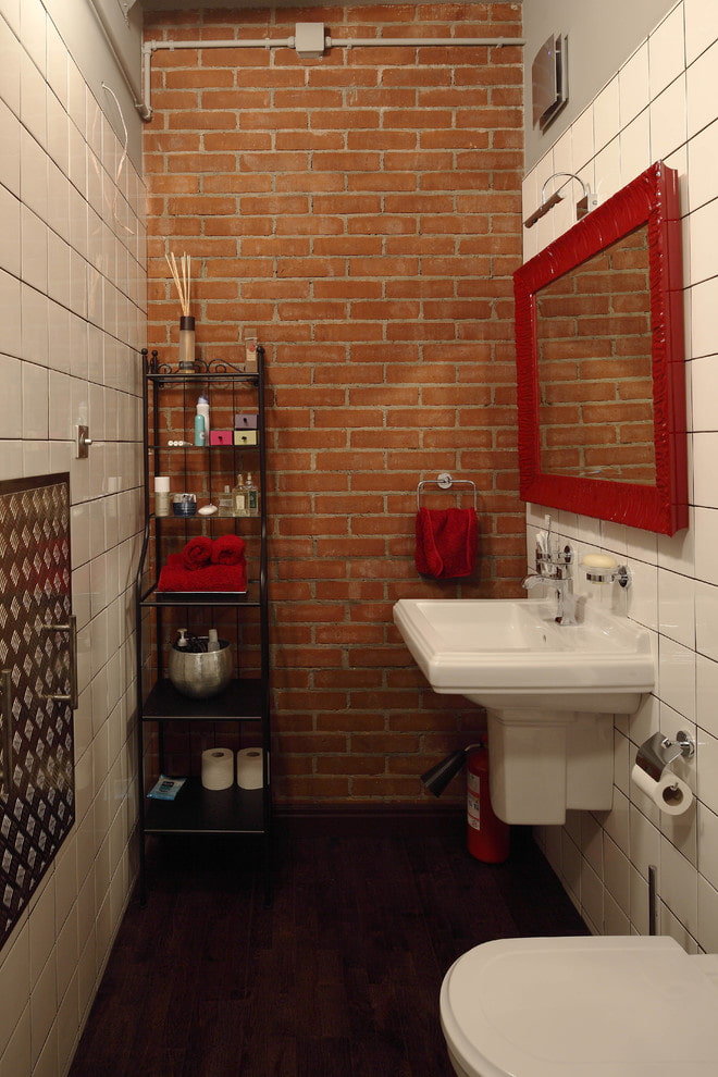 spogulis sarkanā rāmī vannas istabas interjerā