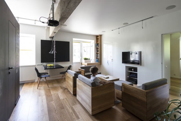 غرفة معيشة في تصميم شقة من ثلاث غرف بمساحة 80 مترًا مربعًا. م.